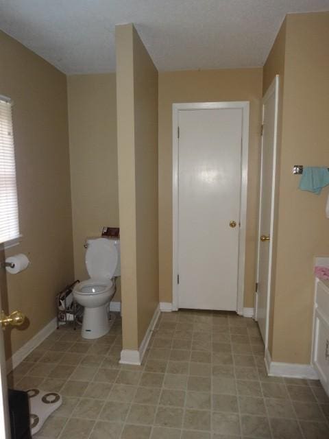 bathroom featuring toilet and vanity