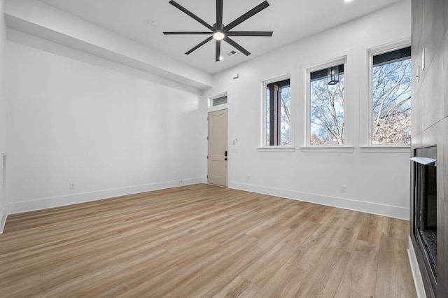 unfurnished living room with ceiling fan and light hardwood / wood-style flooring