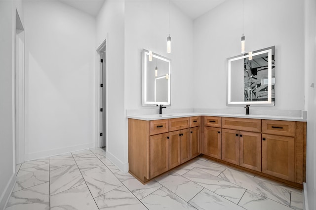 interior space with a towering ceiling, sink, and pendant lighting