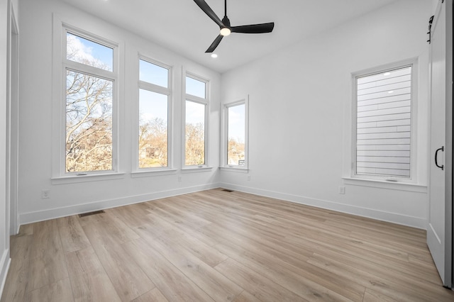 unfurnished sunroom with ceiling fan and a wealth of natural light