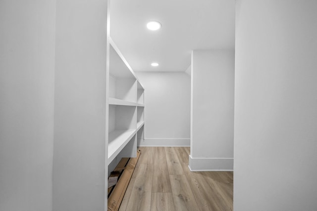 spacious closet featuring light hardwood / wood-style flooring