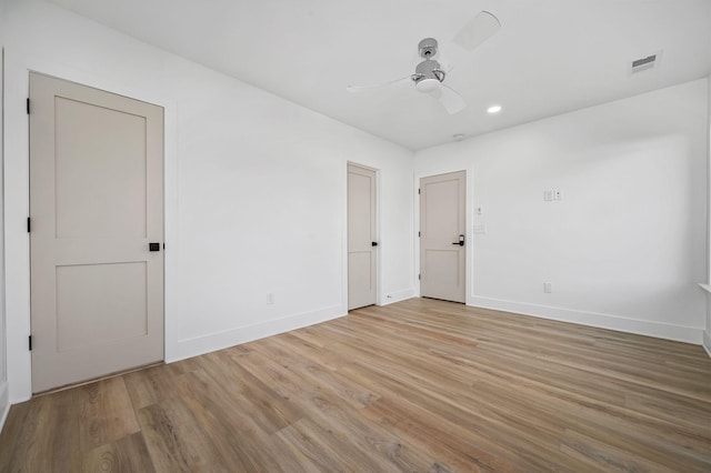 empty room featuring ceiling fan and light hardwood / wood-style flooring