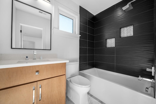 full bathroom featuring toilet, vanity, and tiled shower / bath combo