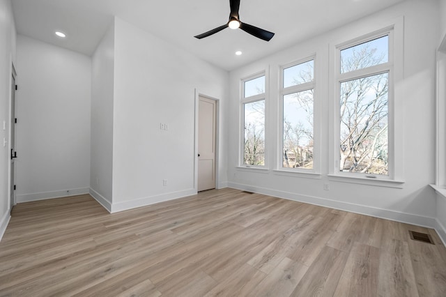 empty room featuring ceiling fan and light hardwood / wood-style floors