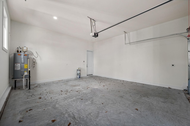 garage featuring water heater and a garage door opener