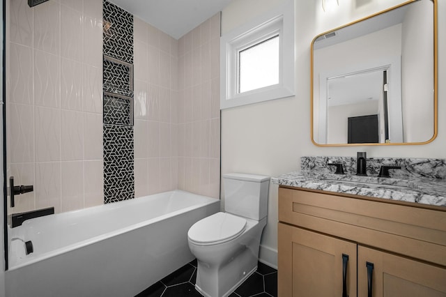 full bathroom with toilet, tile patterned flooring, tiled shower / bath, and vanity