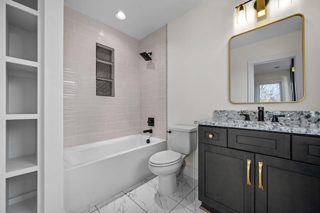 full bathroom featuring toilet, tiled shower / bath, and vanity