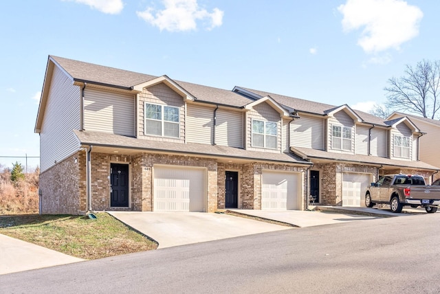 townhome / multi-family property featuring a garage