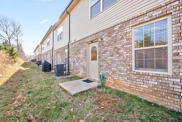 view of side of home with central air condition unit