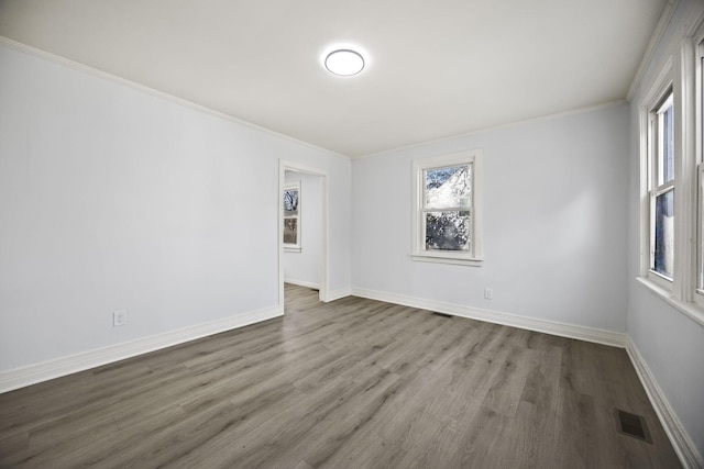 unfurnished room featuring hardwood / wood-style flooring and ornamental molding