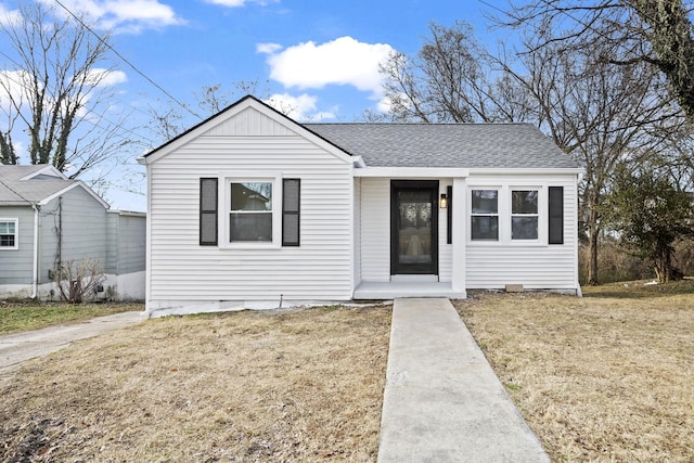 bungalow-style home featuring a front lawn