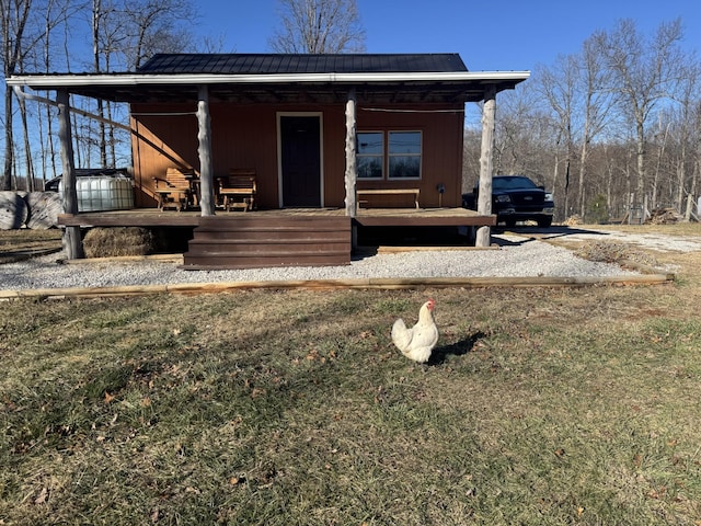 view of front of home featuring covered porch and a front yard