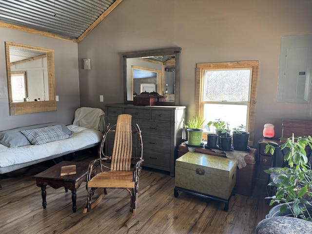 sitting room with wood-type flooring, electric panel, and vaulted ceiling