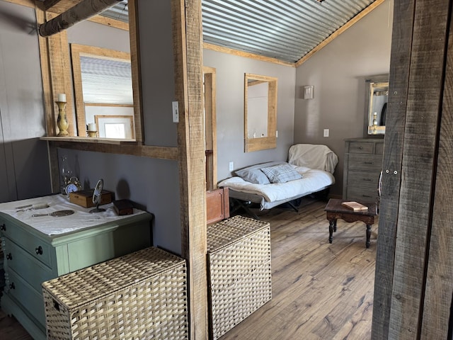 bathroom with wood-type flooring and lofted ceiling