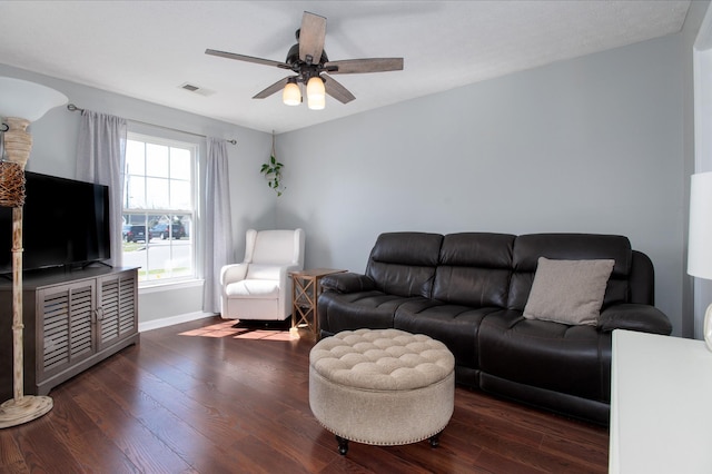 living room with ceiling fan and dark hardwood / wood-style floors