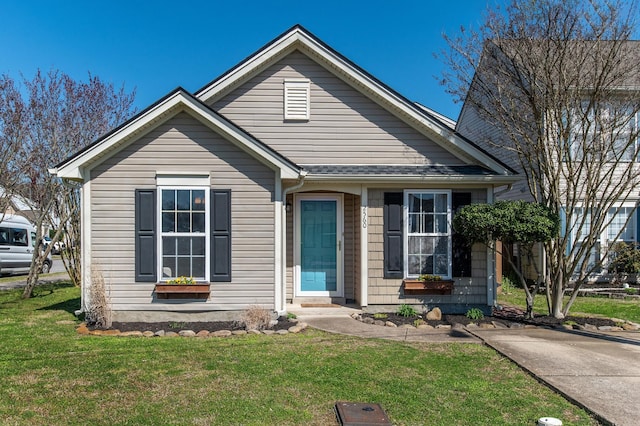 bungalow-style house featuring a front yard