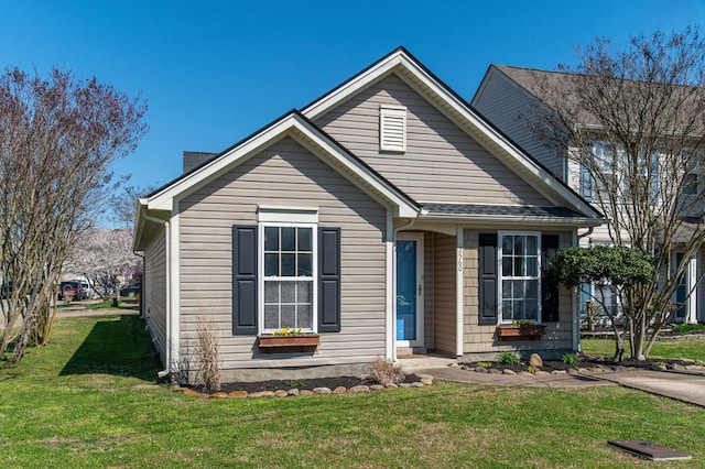 bungalow-style house with a front lawn