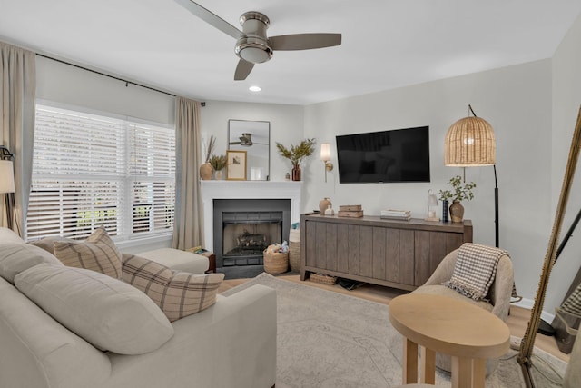 living room featuring light wood-type flooring and ceiling fan