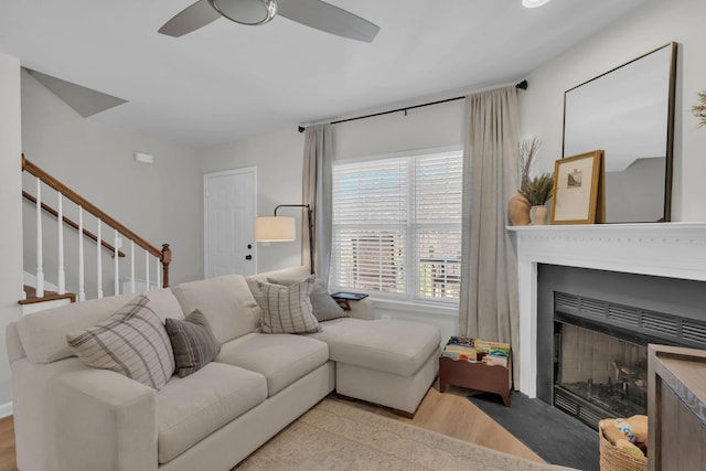 living room featuring ceiling fan and light wood-type flooring