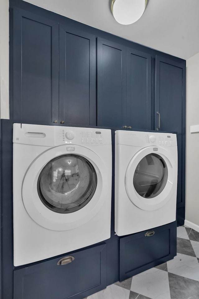 washroom with washing machine and dryer and cabinets