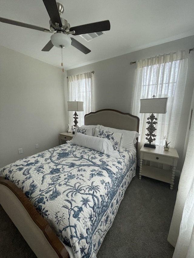 bedroom with ceiling fan and dark carpet