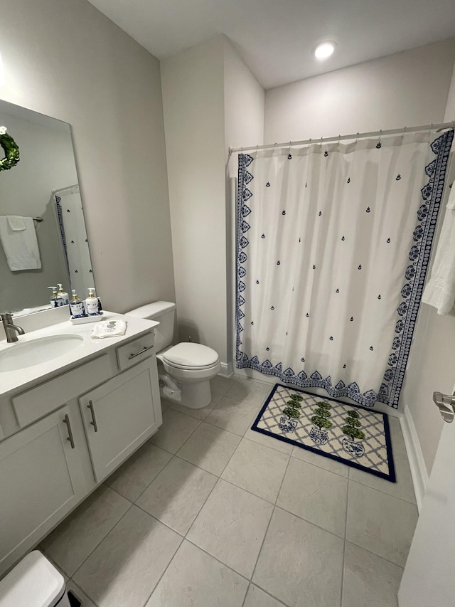 bathroom with curtained shower, tile patterned floors, vanity, and toilet