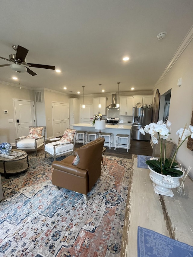 living room with ceiling fan, light wood-type flooring, and crown molding