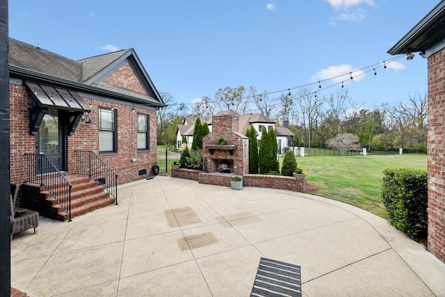 view of patio featuring an outdoor brick fireplace