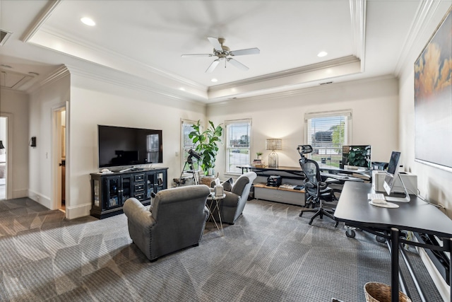 carpeted living room featuring ceiling fan, a tray ceiling, and crown molding