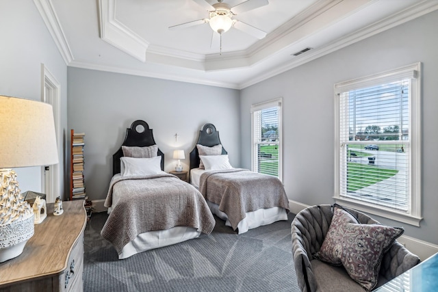 bedroom with ceiling fan, ornamental molding, and a raised ceiling