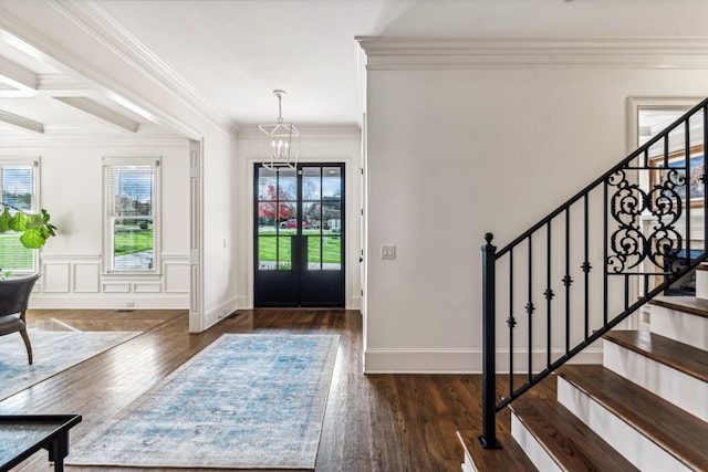 foyer with coffered ceiling, crown molding, dark hardwood / wood-style floors, and a notable chandelier