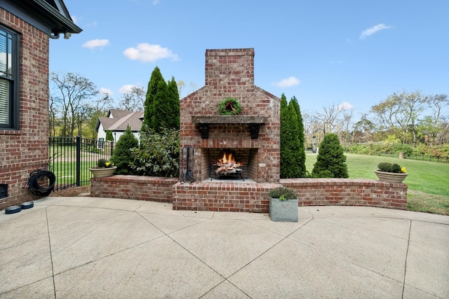 view of patio / terrace featuring an outdoor brick fireplace