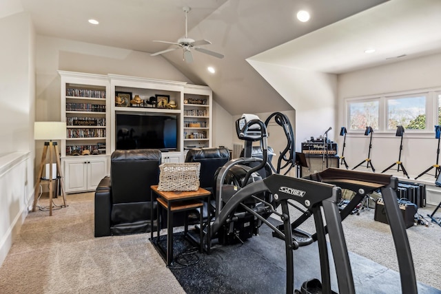 exercise area featuring light carpet, ceiling fan, and lofted ceiling