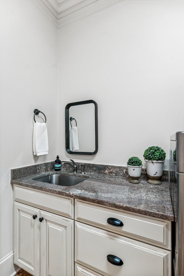 bathroom with vanity and crown molding