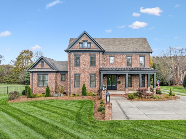 craftsman inspired home featuring a front yard and covered porch