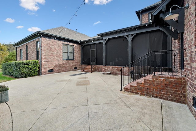 view of patio featuring a sunroom