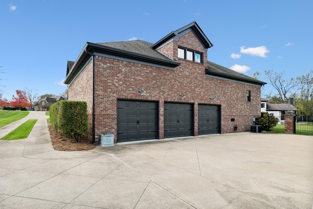 view of side of home featuring a garage