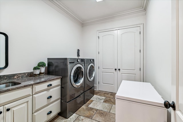 washroom featuring washing machine and dryer, sink, and crown molding