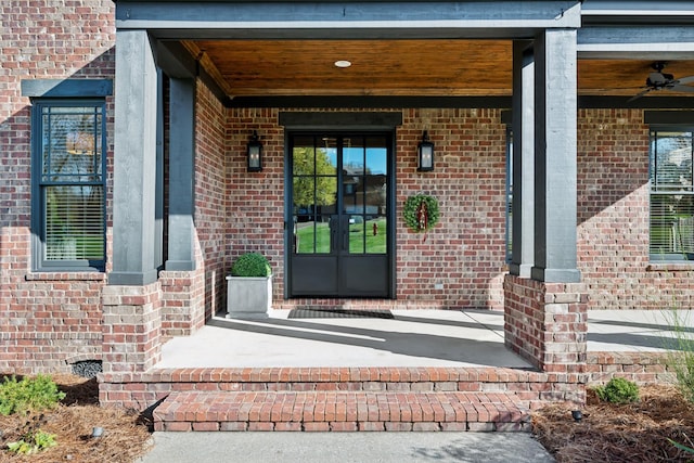 entrance to property with ceiling fan, french doors, and covered porch