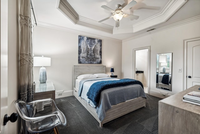 carpeted bedroom featuring ceiling fan, ornamental molding, and a raised ceiling