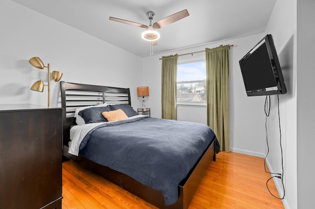 bedroom with ceiling fan and light hardwood / wood-style floors