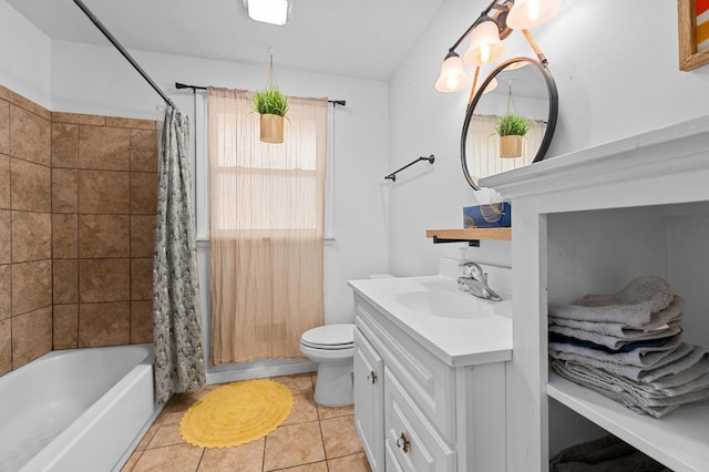 full bathroom featuring toilet, tile patterned floors, vanity, and shower / tub combo with curtain