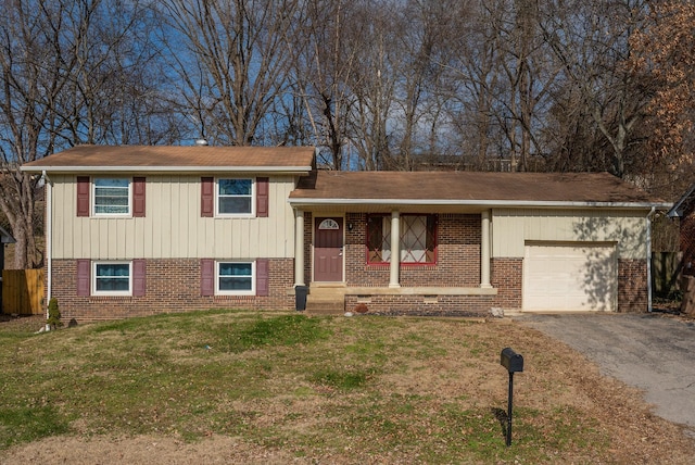 split level home with a garage and a front lawn