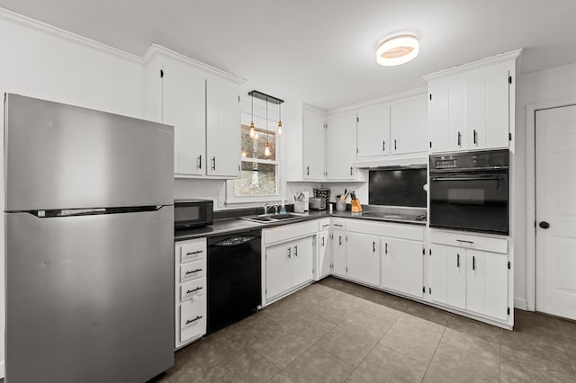 kitchen with white cabinets, black appliances, sink, hanging light fixtures, and light tile patterned floors