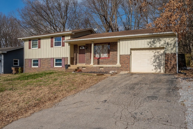 split level home featuring a front lawn and a garage