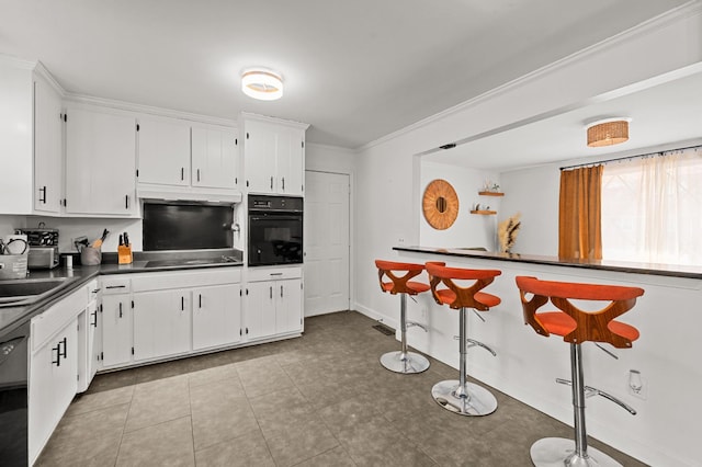 kitchen featuring white cabinetry, ornamental molding, and black appliances