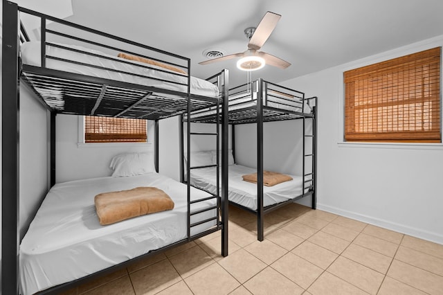 tiled bedroom with ceiling fan