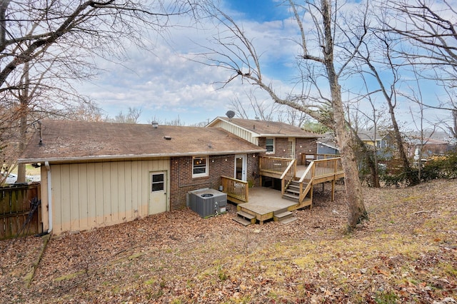 rear view of property featuring a deck and cooling unit