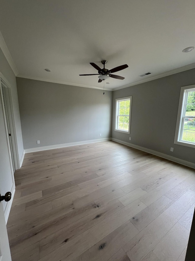 unfurnished room featuring light wood-type flooring, ceiling fan, and crown molding