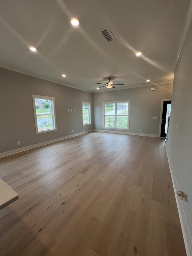 unfurnished room featuring ceiling fan, crown molding, and light wood-type flooring